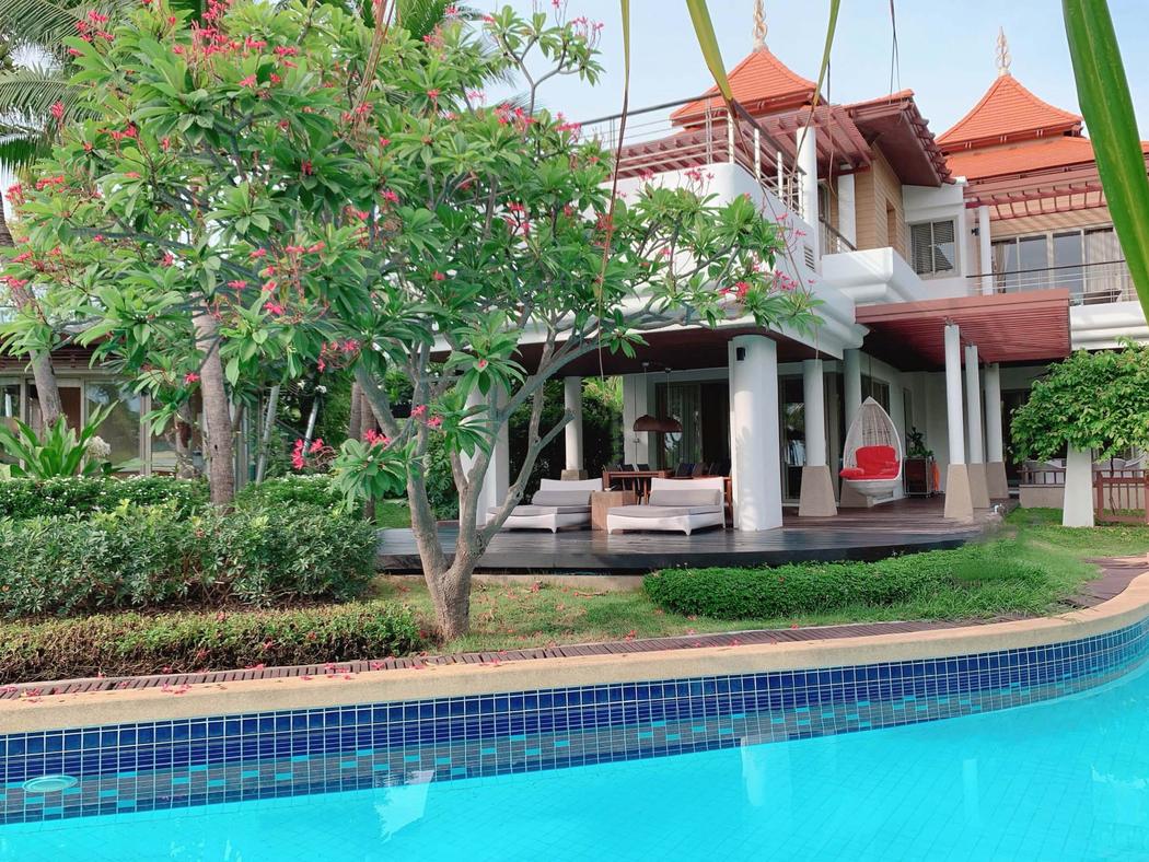 The Main Villa seen across the pool, frangipani in flower beside the covered terrace