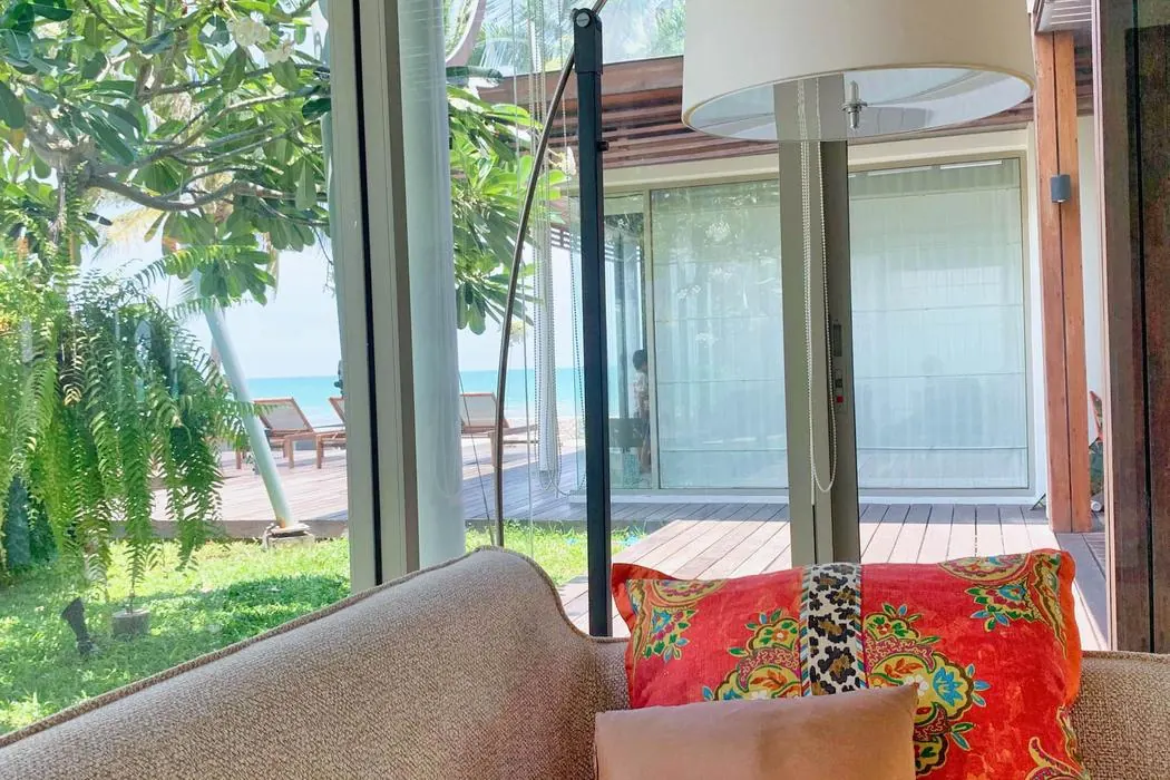 Sofa by the picture window in the 2nd Pavilion, garden and sea beyond