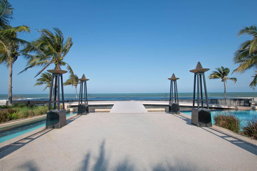 The walkway running between the estate pools down to the beach