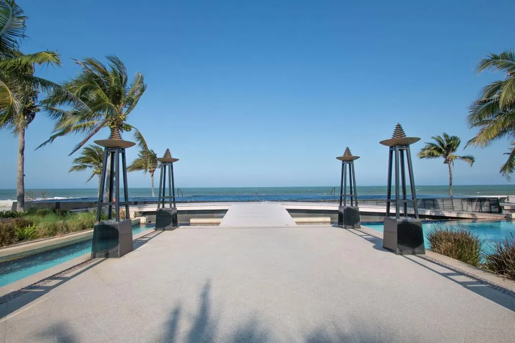 The walkway running between the estate pools down to the beach